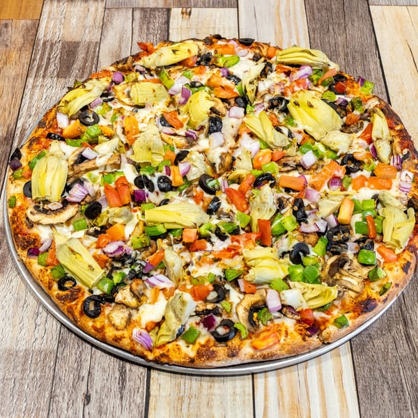 A whole vegetarian pizza with artichokes, mushrooms, olives, bell peppers, and onions.