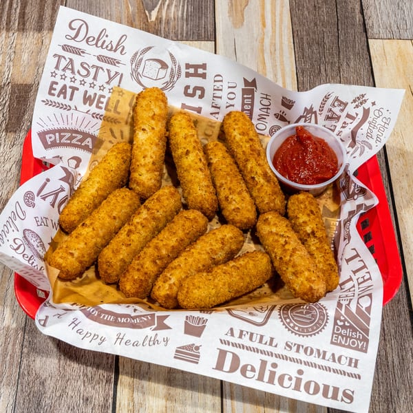 A red basket filled with golden-brown mozzarella sticks and a small cup of marinara sauce.