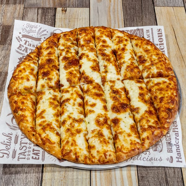 Cheesy breadsticks, golden brown and cut into strips, on a branded paper liner.