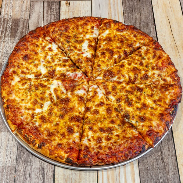 A whole cheese pizza, cut into eight slices, on a metal pan over a wooden table.